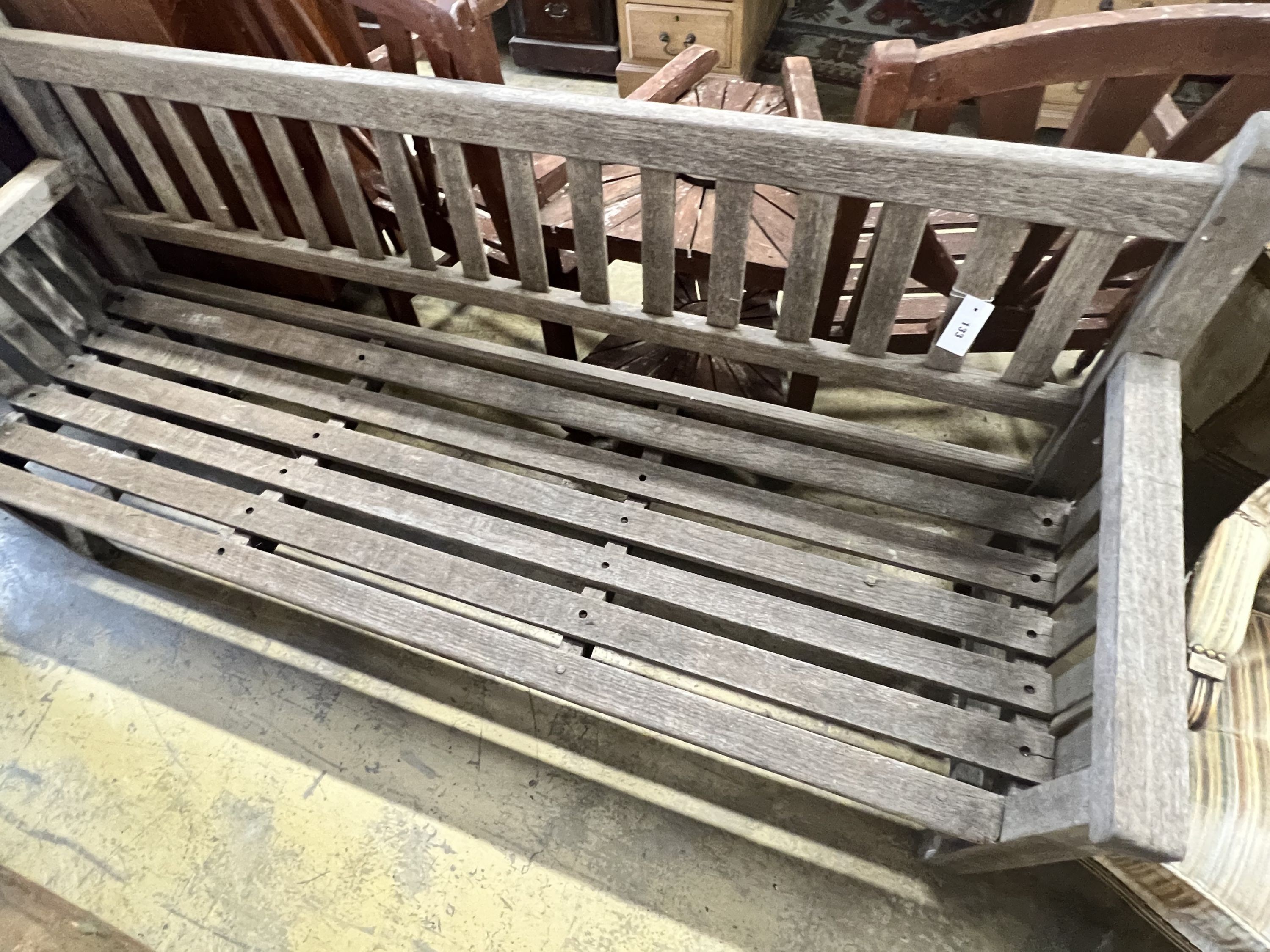 A weathered teak slatted garden bench, width 182cm depth 58cm height 92cm